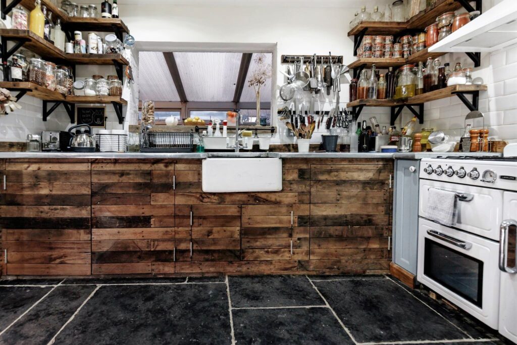 Modern rustic wooden kitchen with Belfast butlers sink and reclaimed wooden cabinet doors.