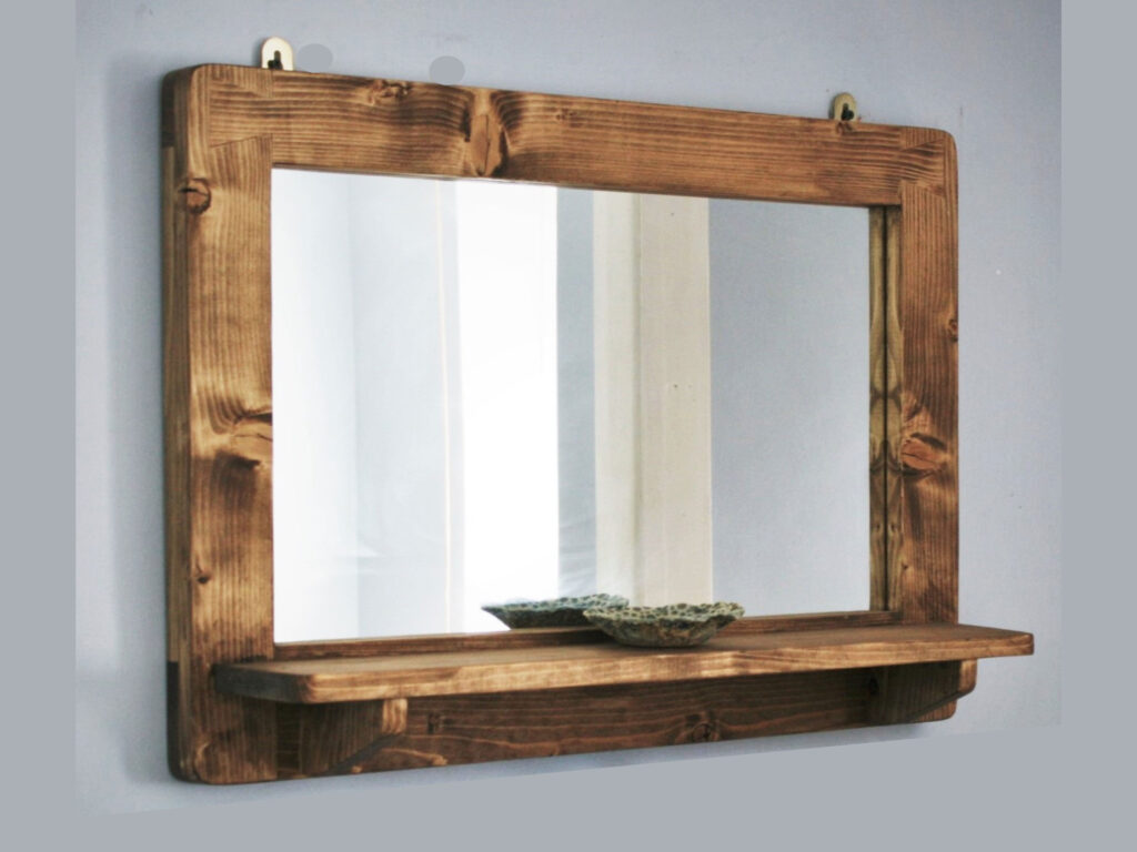 Wooden mirror with shelf as seen from the side.