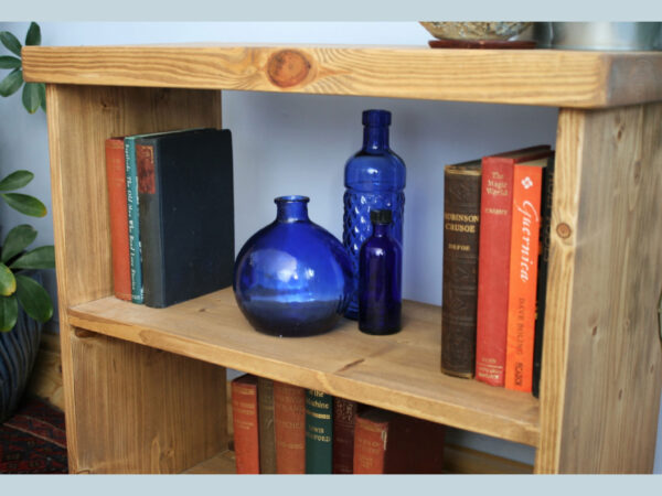 Small rustic bookcase in natural sustainable wood, shelf view.