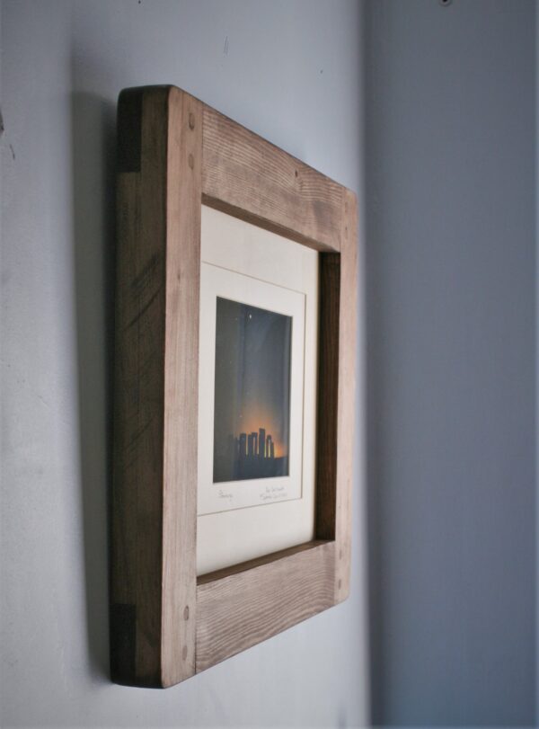 Large A3 picture frame in chunky natural wood on the wall