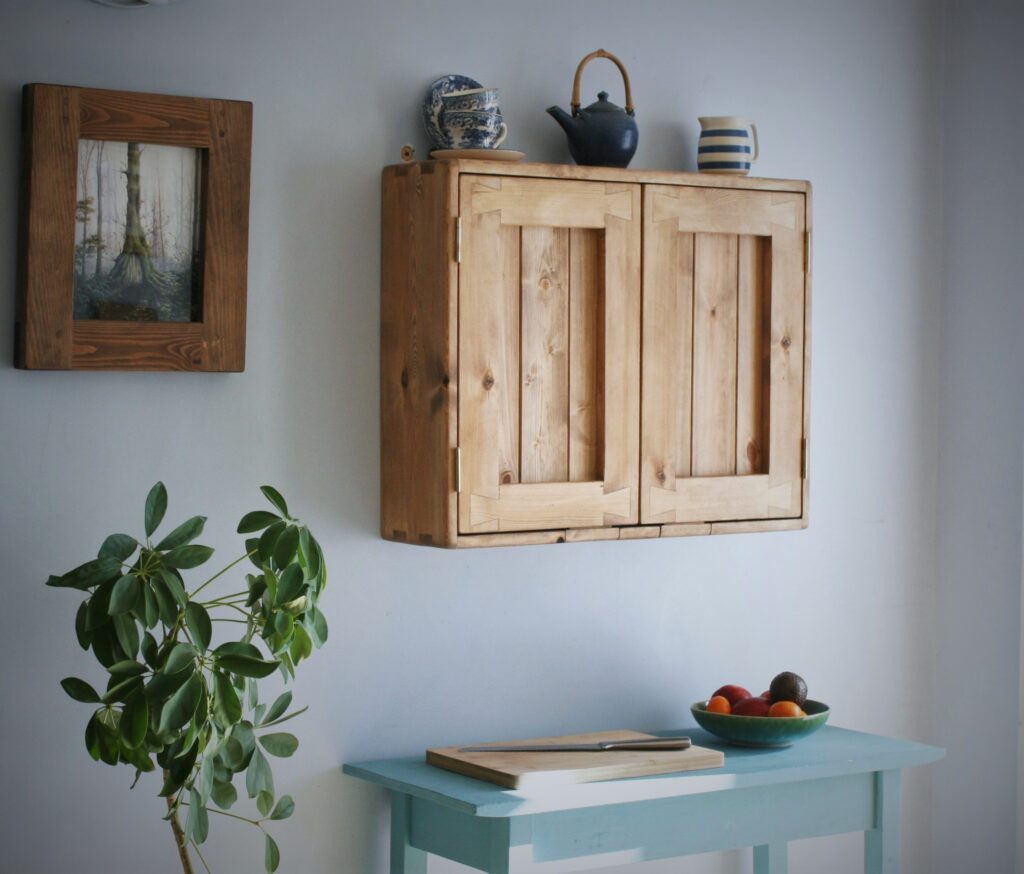 Wooden kitchen cabinet in rustic cottage style, long view.