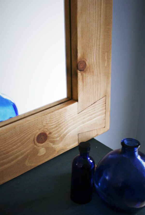 Chunky wooden mirror, close up of dovetail joint frame decoration.