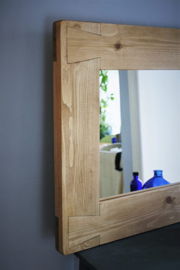 Chunky wooden mirror, close up of thick dovetail frame. Bespoke handmade from natural, sustainable wood in Somerset UK