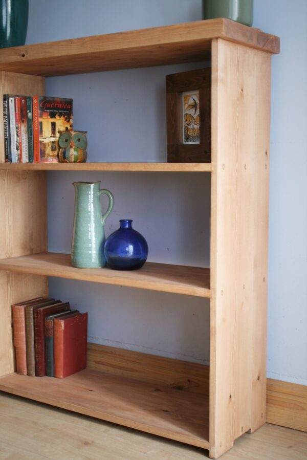 Large irregular wooden bookcase in chunky rustic natural wood, handmade in Somerset UK. Side view.
