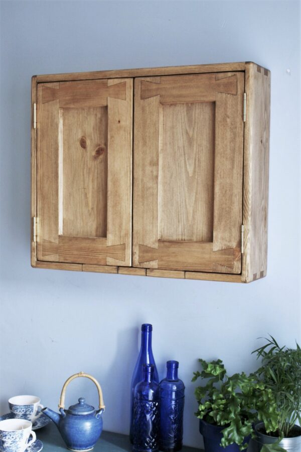 Wide kitchen cabinet in natural, rustic wood with 2 doors, side view.