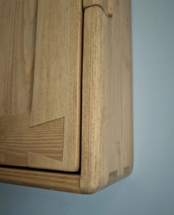 Slim wooden bathroom wall cabinet detail of traditional dovetail and finger joint.