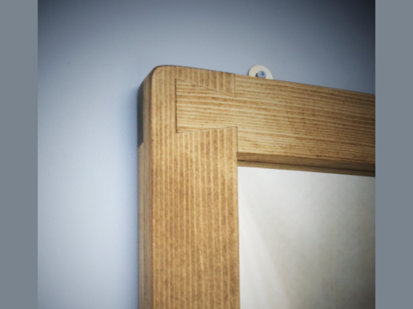 Dovetail as functional decoration on our wooden mirror frame, handmade in the UK.