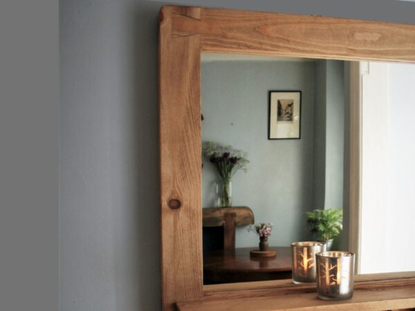 Large mirror with shelf and chunky iron hooks in our modern rustic style. Close up of shelf detail.
