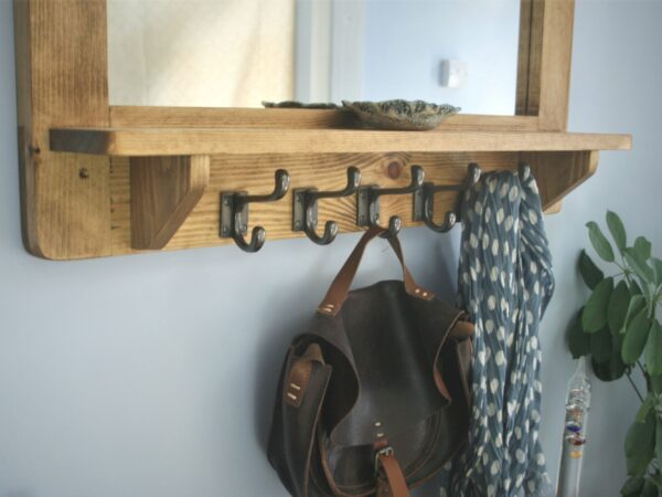 Large mirror with shelf and chunky iron hooks in our modern rustic style. Detail of coat hooks.