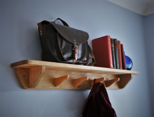 Hallway shelf with hooks and rustic wooden coat rack. Close view. Designed and handmade in Somerset UK