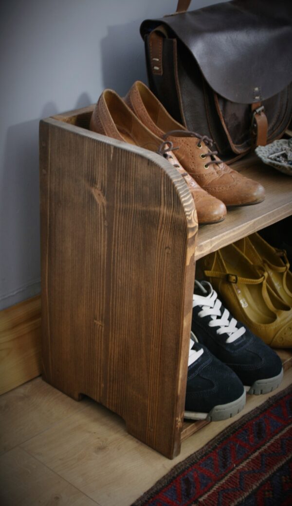 Small wooden shoe rack, close up of left curved side.