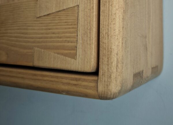 Detail of door panel for handmade wooden kitchen cabinet.