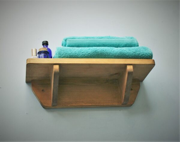 Small wooden bathroom shelf in chunky natural wood. For cosmetics, plants and towels. Low view, handmade in Somerset UK