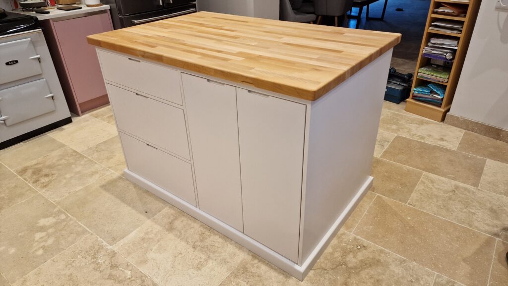 Large minimalist modern kitchen island with a solid wooden worktop in Oak and Ash. Handmade in Somerset UK.