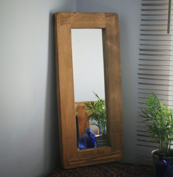 Wooden wall mirror, dark wood finish.