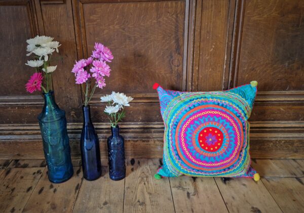 Colourful embroidered cushion cover with blue glass, abstract pattern in pink, blue and green. Bohemian rustic homeware from Somerset.