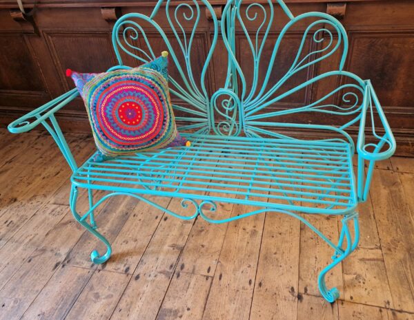 Colourful embroidered cushion cover, on peacock bench in pink, blue and green. Bohemian rustic homeware from Somerset.