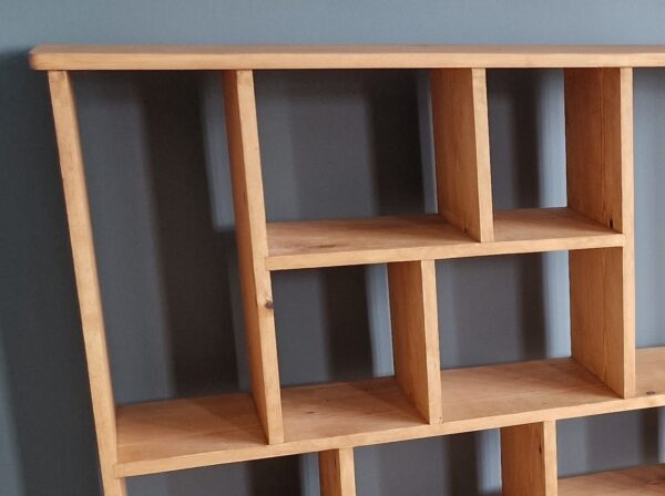 Large irregular bookcase in chunky natural wood, close up of top, uneven modern rustic bookcase and room divider custom handmade in Somerset UK