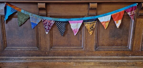 Colourful silk bunting handmade from recycled sari fabric. Portable decorative garlands for boho rustic home, Somerset UK.
