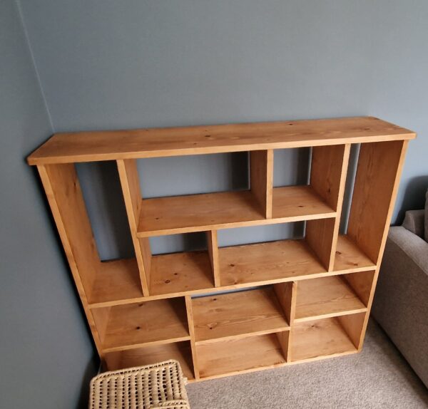 Non uniform bookcase and room divider in chunky natural wood, deep shelves, uneven modern rustic bookshelf, custom handmade in Somerset UK. Side view.