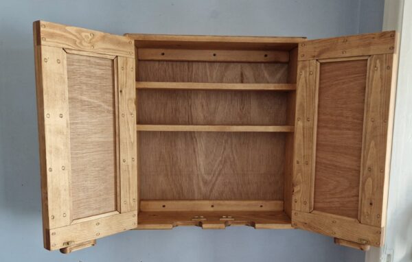 Wooden medicine cabinet with mirror doors open