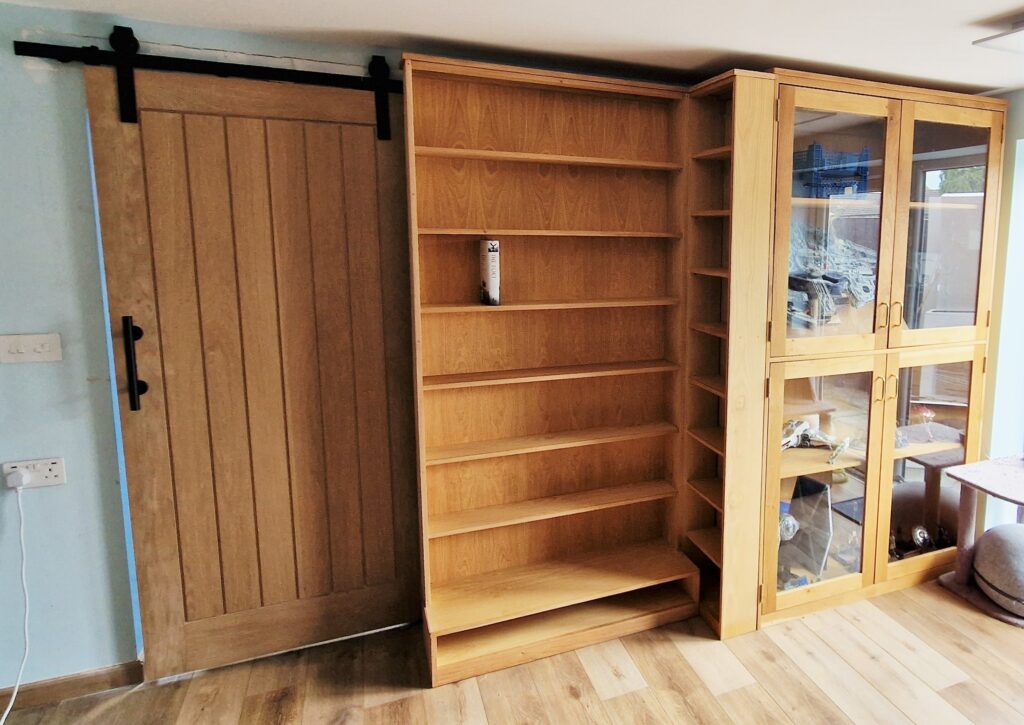Rustic inbuilt bookshelves and glass door bookcase in natural wood from Somerset UK