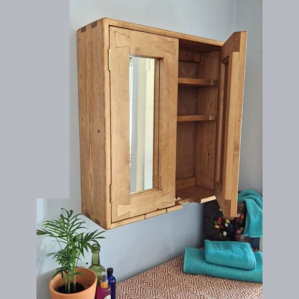Wooden medicine cabinet with one mirror door open