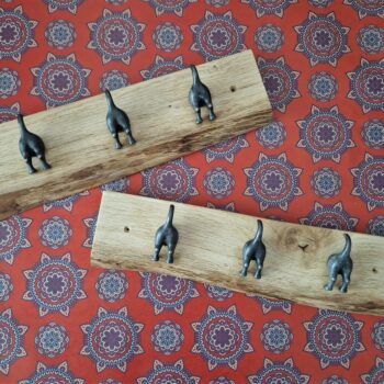 Live edge coat rack with 3 ‘waggy dog tails’ cast iron hooks on a chunky natural Oak plaque, boho wallpaper.