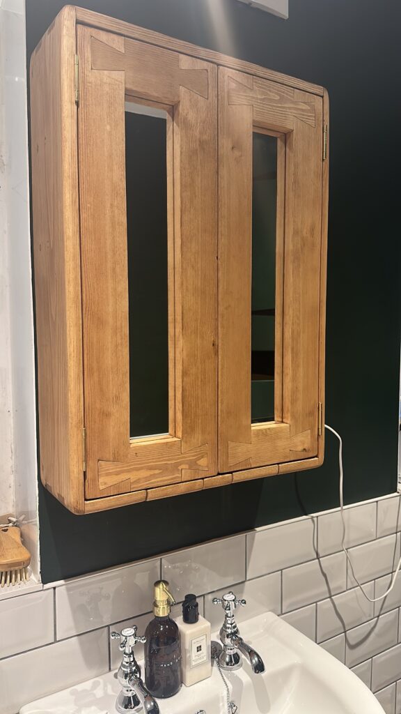 Modern rustic bathroom mirror cabinet with dovetail detailing, in light Danish Oil.