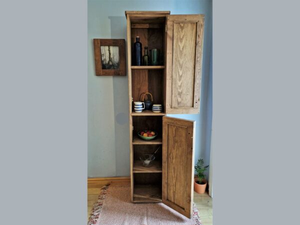Narrow farmhouse larder cupboard and rustic slim freestanding kitchen pantry cabinet from Somerset UK, doors open.