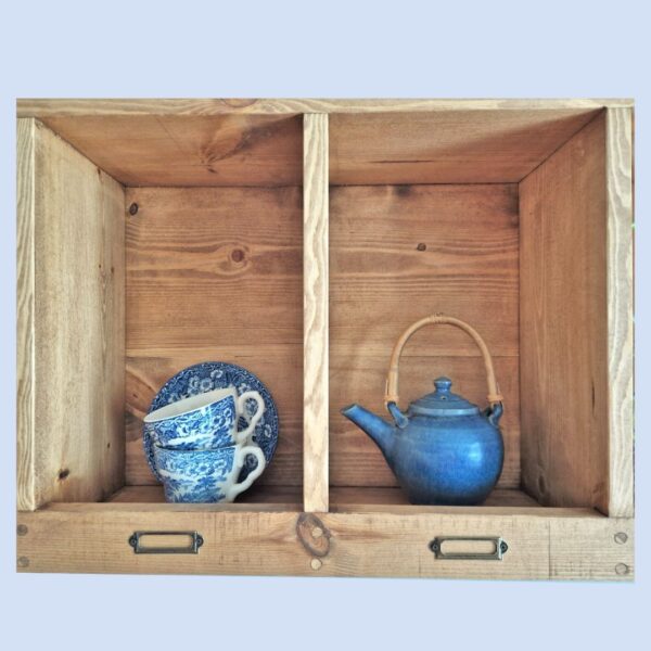 Pigeon hole kitchen shelf and curio display unit, rustic vintage mug holder from Somerset UK, close up.