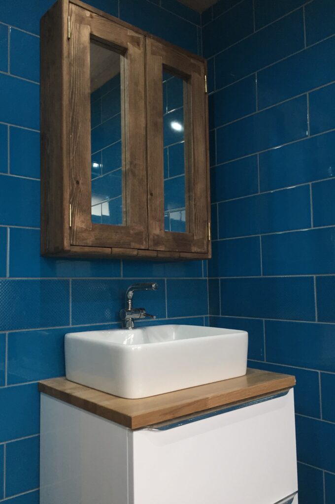 Modern rustic dark wood bathroom mirror cabinet over a butlers sink, handmade in Somerset UK.
