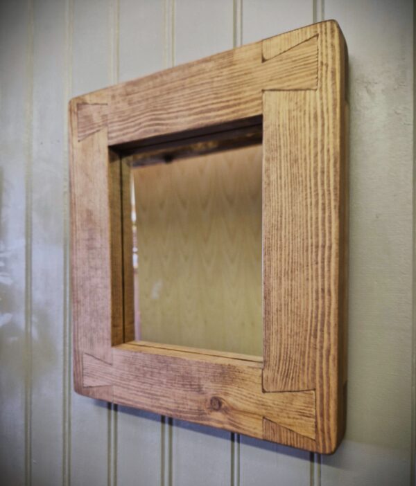 Small wood frame mirror handmade by us in Somerset UK in our modern rustic style, cottage cabin wall mirror, side view.