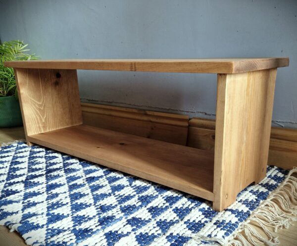 Low wooden shoe rack, modern rustic single tier shoe shelf in natural, sustainable wood from Somerset UK, side view.