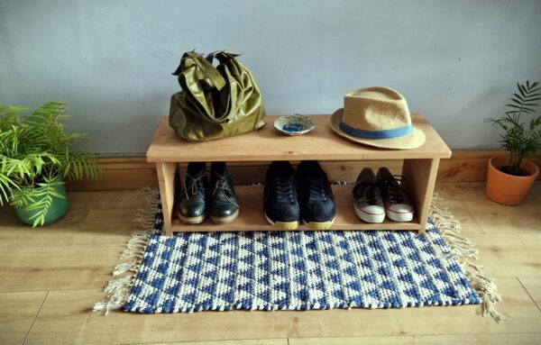 Low wooden shoe rack, modern rustic single tier shoe shelf in natural, sustainable wood from Somerset UK with decorative plants.