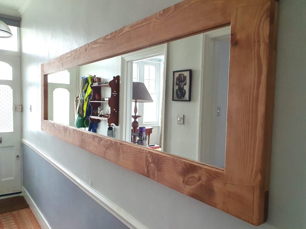 Extra large hallway wall mirror in natural rustic wood, seen in it's new home.