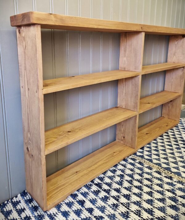 Rustic double bookcase and divided compartment shelving unit, wide, slim wooden bookshelves handmade in Somerset UK, empty side view.