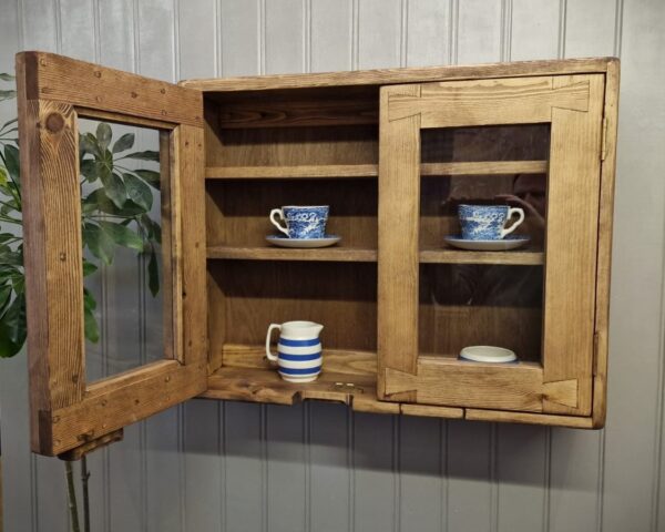 Rustic kitchen glass cabinet, curio display wooden wall cabinet with left door open, handmade in Somerset UK.