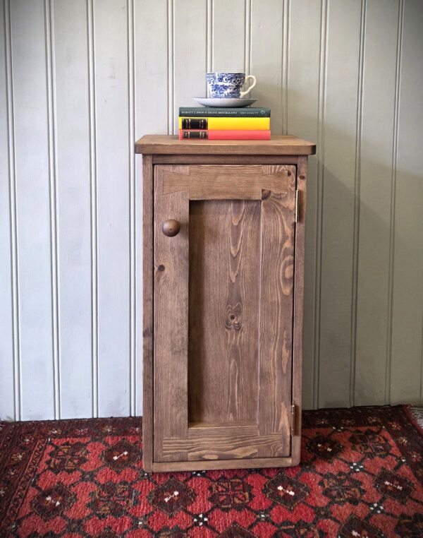 Slim wooden bathroom cupboard and dark wood bedside cabinet, custom made in Somerset UK from natural wood.